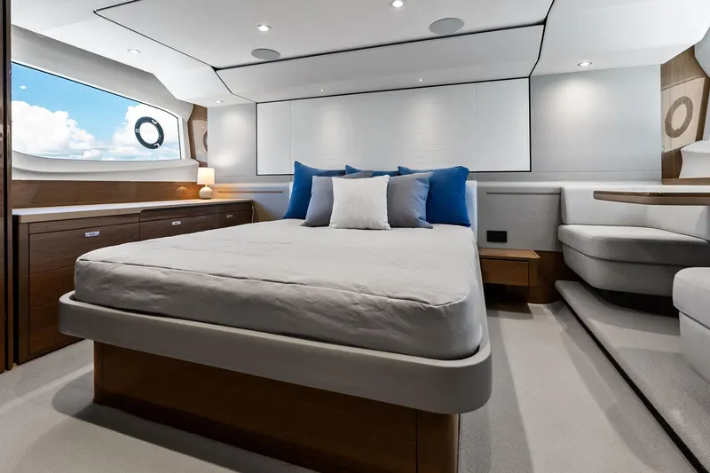Salty Cowboy Yacht Photos Pics Luxurious bedroom interior of 2022 Princess 55 Flybridge yacht with modern design and ocean view.