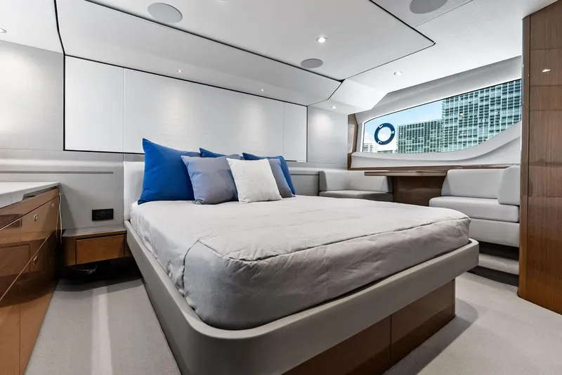 Salty Cowboy Yacht Photos Pics Luxurious bedroom interior of 2022 Princess 55 Flybridge yacht with modern design and large window.