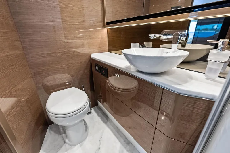 Salty Cowboy Yacht Photos Pics Luxurious bathroom in 2022 Princess 55 Flybridge yacht with modern fixtures and elegant design.