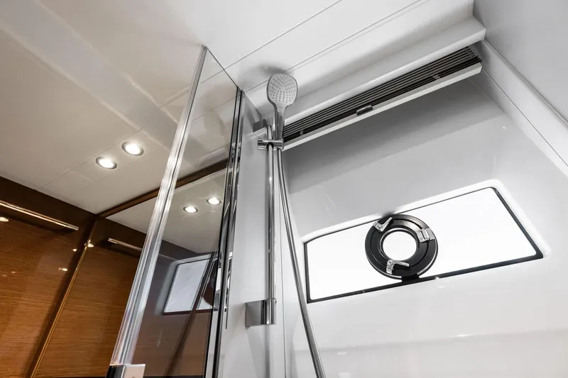 Salty Cowboy Yacht Photos Pics Luxurious bathroom interior of 2022 Princess 55 Flybridge yacht, featuring modern shower design.