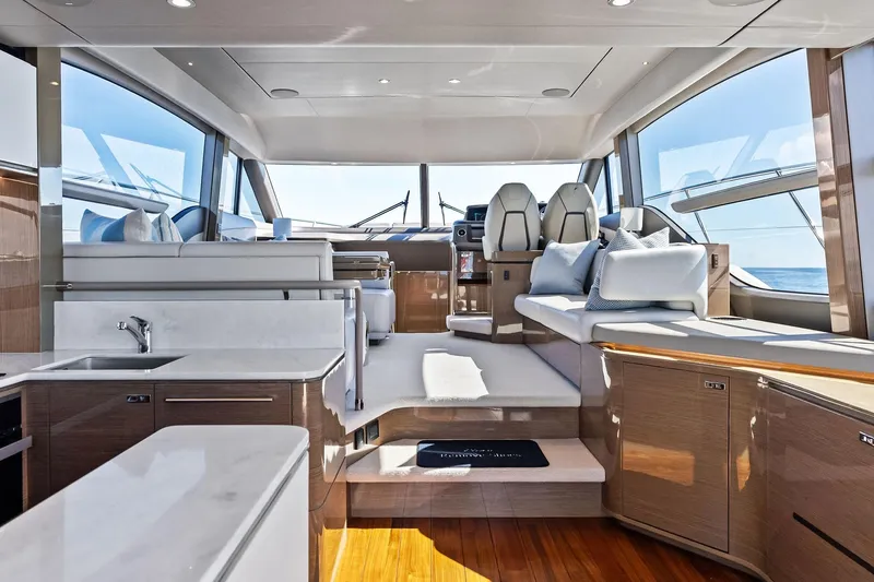 Salty Cowboy Yacht Photos Pics Luxurious interior of 2022 Princess 55 Flybridge yacht with modern design and panoramic windows.