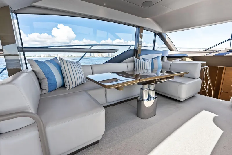 Salty Cowboy Yacht Photos Pics Luxurious interior of 2022 Princess 55 Flybridge yacht with elegant seating and ocean view.