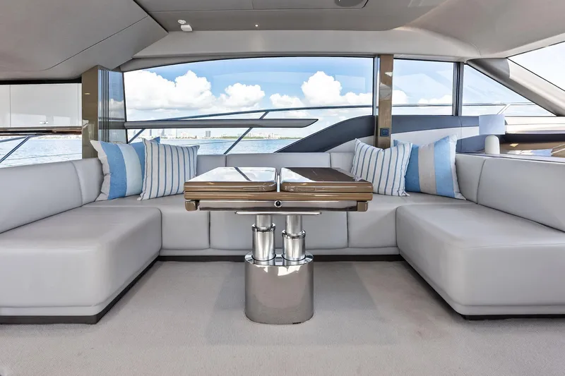 Salty Cowboy Yacht Photos Pics Luxurious interior of 2022 Princess 55 Flybridge yacht with elegant seating and ocean view.