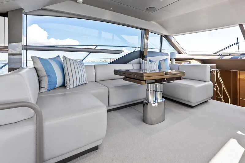 Salty Cowboy Yacht Photos Pics Luxurious interior of 2022 Princess 55 Flybridge yacht with modern seating and ocean view.