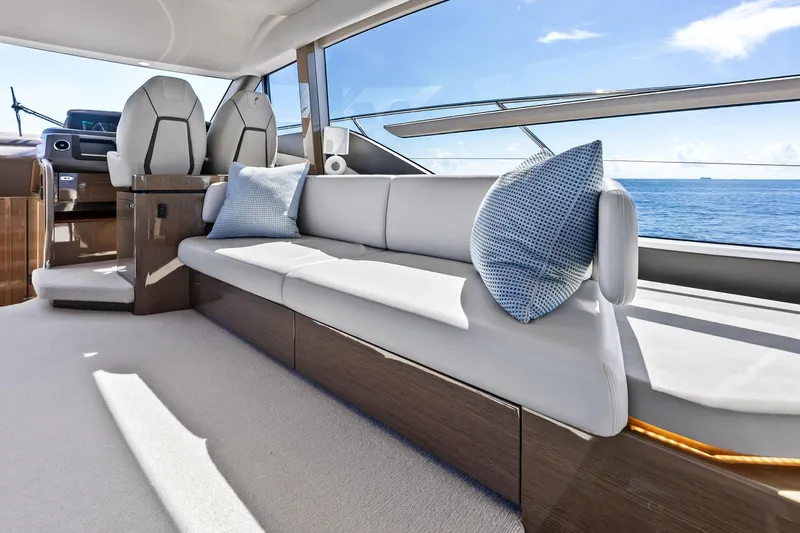Salty Cowboy Yacht Photos Pics Luxurious interior of 2022 Princess 55 Flybridge yacht with elegant seating and ocean view.