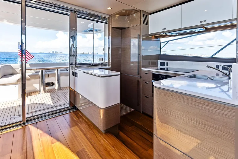Salty Cowboy Yacht Photos Pics Luxurious 2022 Princess 55 Flybridge yacht interior with modern kitchen and ocean view.