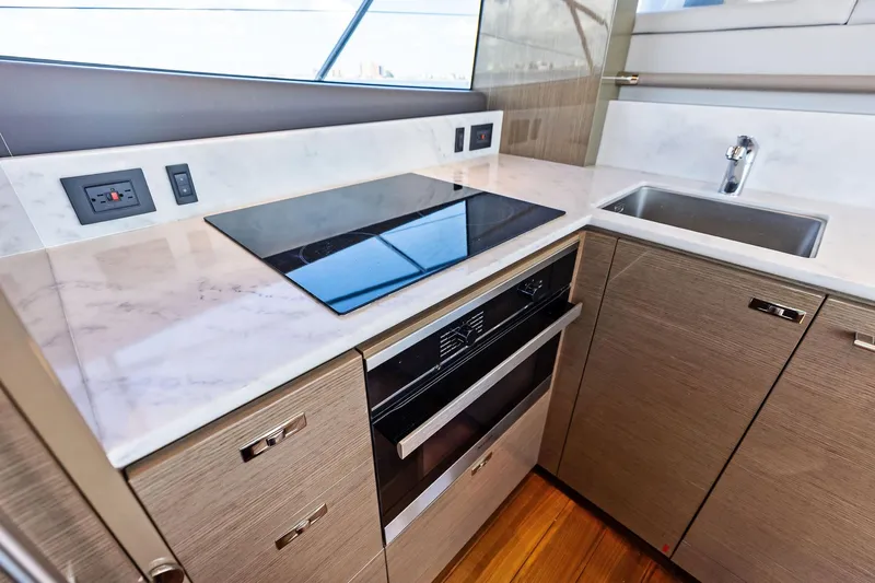 Salty Cowboy Yacht Photos Pics Modern kitchen in 2022 Princess 55 Flybridge yacht with sleek appliances and marble countertops.