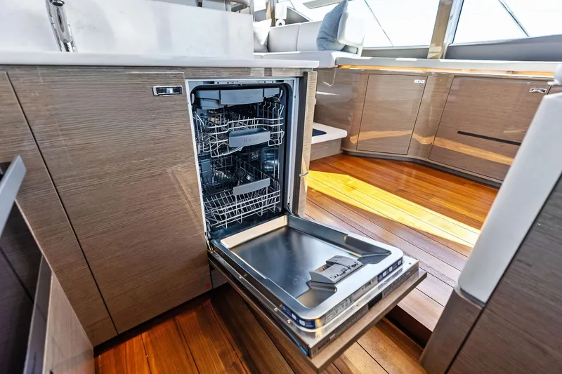 Salty Cowboy Yacht Photos Pics Open dishwasher in modern kitchen of 2022 Princess 55 Flybridge yacht.