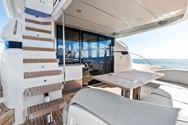 Salty Cowboy Yacht Photos Pics Luxurious 2022 Princess 55 Flybridge yacht with elegant outdoor seating and ocean view.