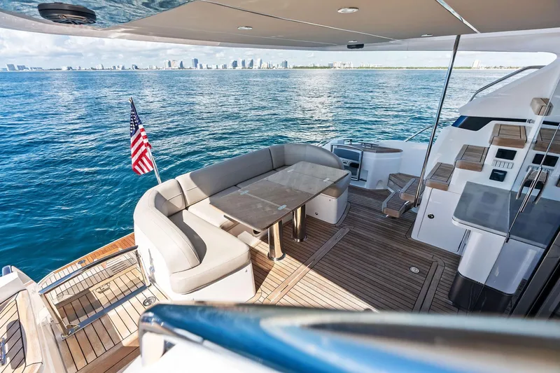 Salty Cowboy Yacht Photos Pics Luxurious 2022 Princess 55 flybridge yacht with spacious deck and ocean view.