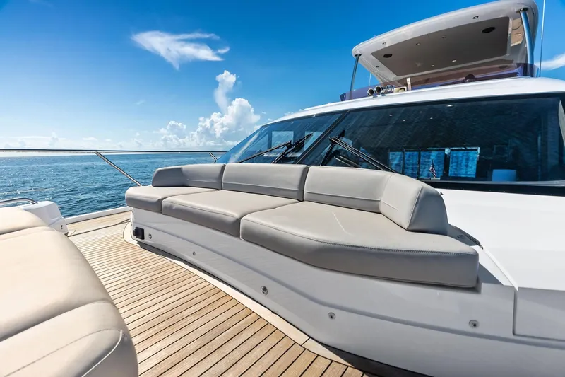Salty Cowboy Yacht Photos Pics Luxurious 2022 Princess 55 flybridge yacht with elegant deck seating and ocean view.