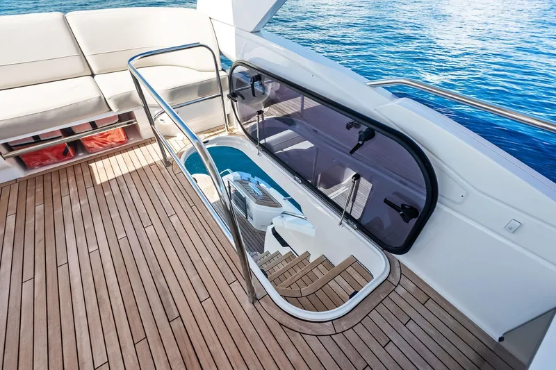 Salty Cowboy Yacht Photos Pics Luxurious 2022 Princess 55 Flybridge yacht with elegant teak deck and ocean view.