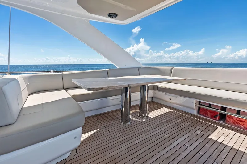 Salty Cowboy Yacht Photos Pics Luxurious 2022 Princess 55 flybridge yacht with spacious seating and ocean view.