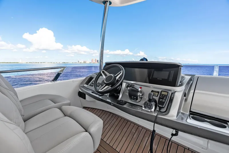 Salty Cowboy Yacht Photos Pics Flybridge helm of 2022 Princess 55 yacht with ocean view and modern controls.