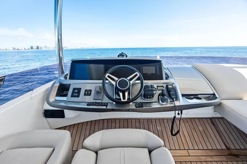 Salty Cowboy Yacht Photos Pics Flybridge helm of 2022 Princess 55 yacht with ocean view and modern controls.