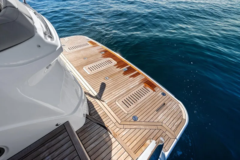 Salty Cowboy Yacht Photos Pics Luxury Princess 55 flybridge yacht deck, 2022 model, overlooking serene ocean waters.