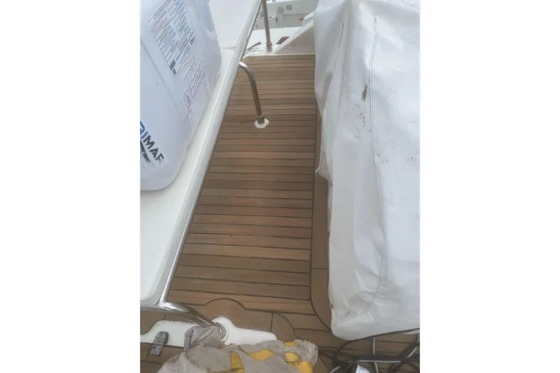  Yacht Photos Pics Teak deck of 2004 Cantieri Estensi GOLDSTAR 440 FLY yacht, partially covered.