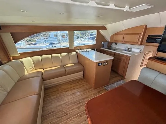  Yacht Photos Pics Luxurious interior of 2007 Jersey Cape 44 CNV yacht with leather seating and modern kitchen.
