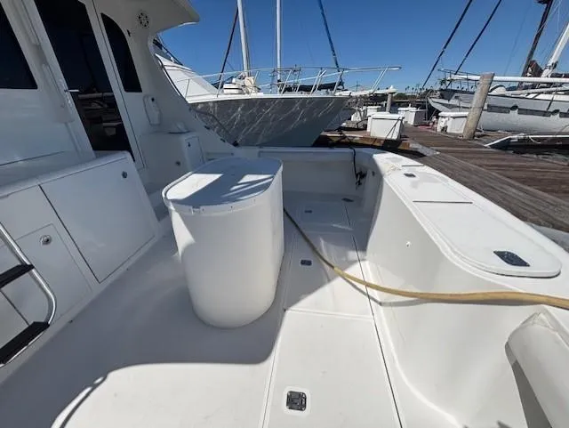  Yacht Photos Pics 2007 Jersey Cape 44 CNV boat deck with storage and seating at marina.