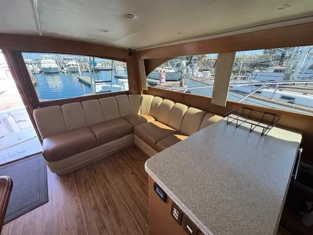  Yacht Photos Pics Luxurious 2007 Jersey Cape 44 CNV yacht interior with spacious seating and marina view.