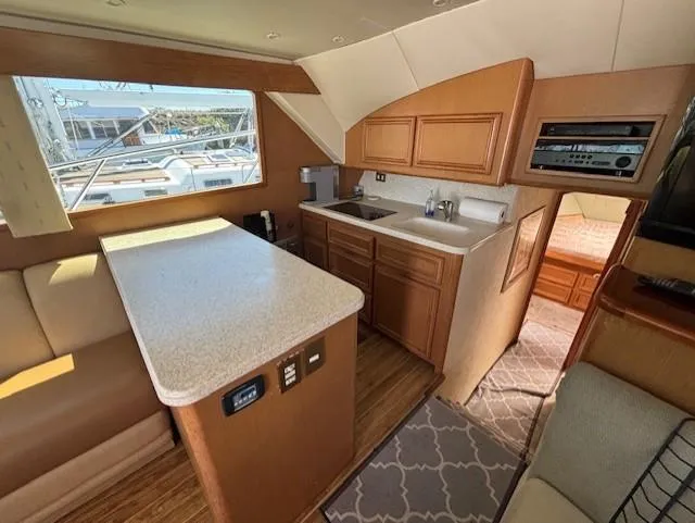  Yacht Photos Pics Interior of 2007 Jersey Cape 44 CNV yacht with kitchen and seating area.