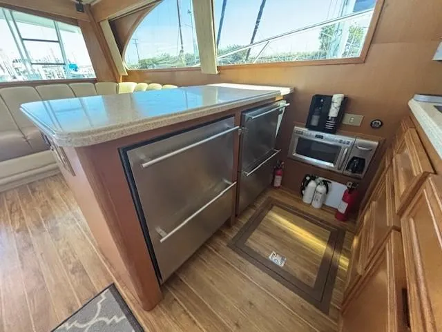  Yacht Photos Pics Interior of 2007 Jersey Cape 44 CNV yacht with modern kitchen appliances and wood flooring.