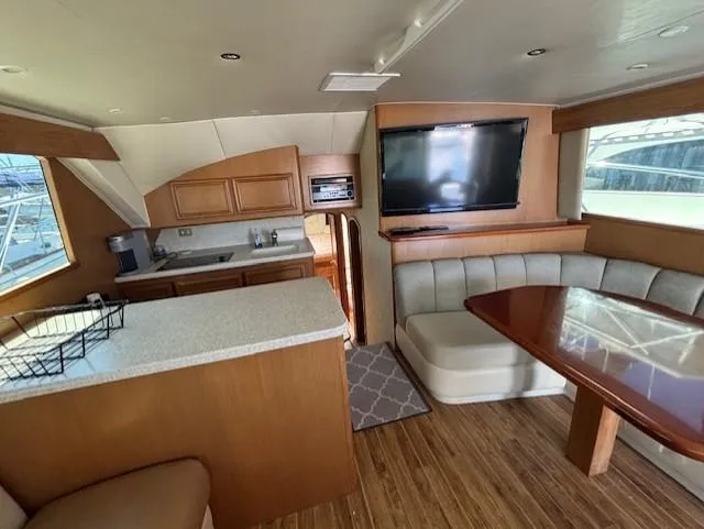  Yacht Photos Pics Luxurious interior of 2007 Jersey Cape 44 CNV yacht with kitchen and seating area.