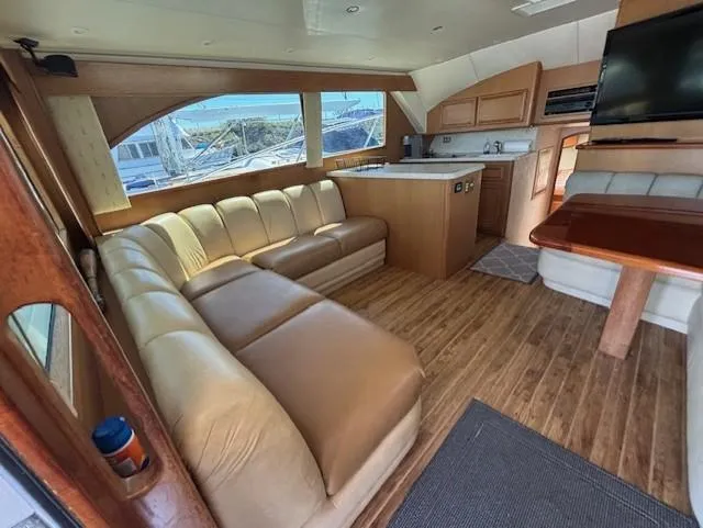  Yacht Photos Pics Luxurious interior of 2007 Jersey Cape 44 CNV yacht with leather seating and wooden flooring.