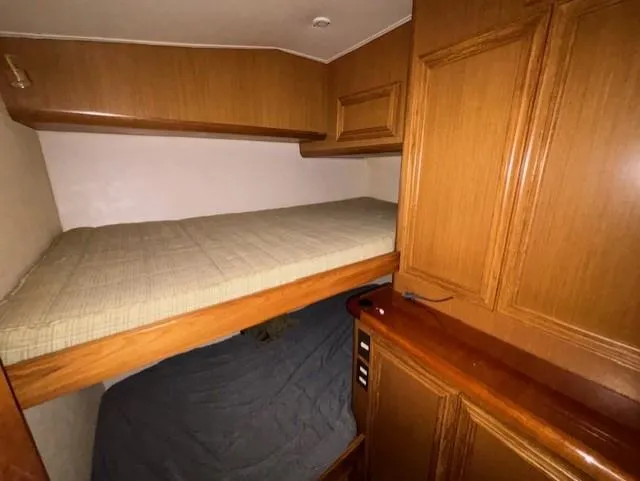 Yacht Photos Pics 2007 Jersey Cape 44 CNV cabin with wooden interior and bunk beds.