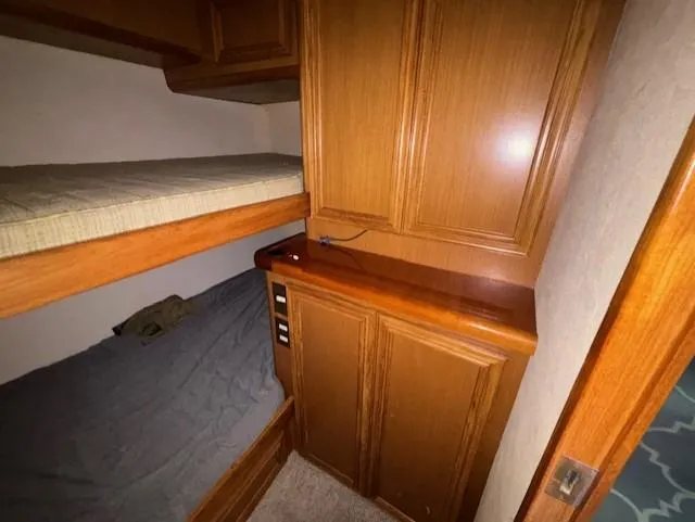  Yacht Photos Pics Interior of 2007 Jersey Cape 44 CNV with wooden cabinets and bunk beds.