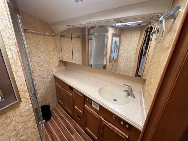  Yacht Photos Pics Luxurious bathroom in 2007 Jersey Cape 44 CNV yacht with elegant wood and beige decor.