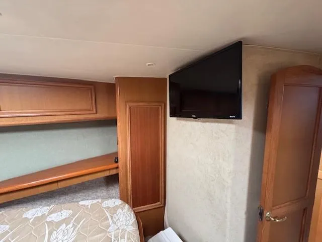  Yacht Photos Pics Interior of 2007 Jersey Cape 44 CNV with TV and wooden cabinetry.