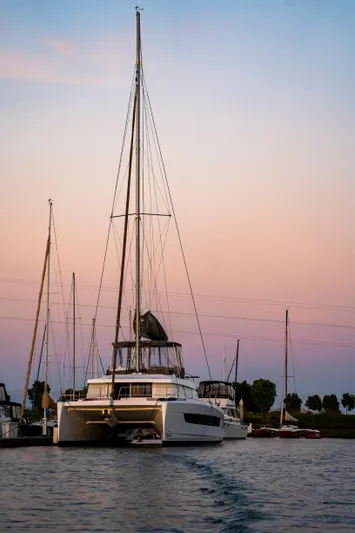 Blureverie Yacht Photos Pics 2021 Bali 4.8 catamaran at sunset in a serene marina setting.