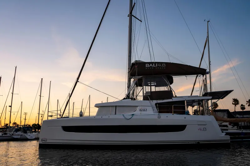 Blureverie Yacht Photos Pics 2021 Bali 4.8 catamaran docked at sunset, showcasing sleek design and modern features.
