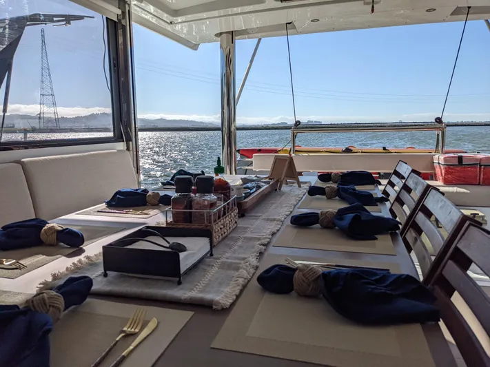 Blureverie Yacht Photos Pics Dining setup on a 2021 Bali 4.8 catamaran with ocean view.