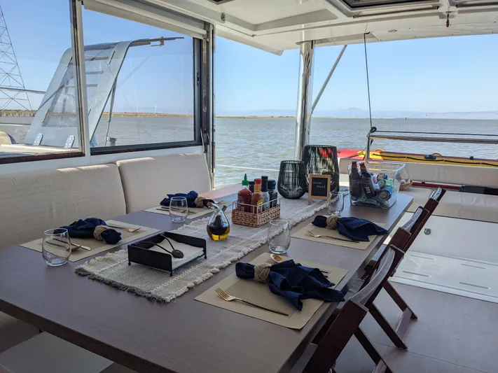 Blureverie Yacht Photos Pics Luxurious dining setup on a 2021 Bali 4.8 yacht with ocean view.