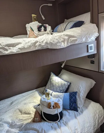 Blureverie Yacht Photos Pics Cozy bunk beds in a 2021 Bali 4.8 yacht cabin with plush pillows and decor.