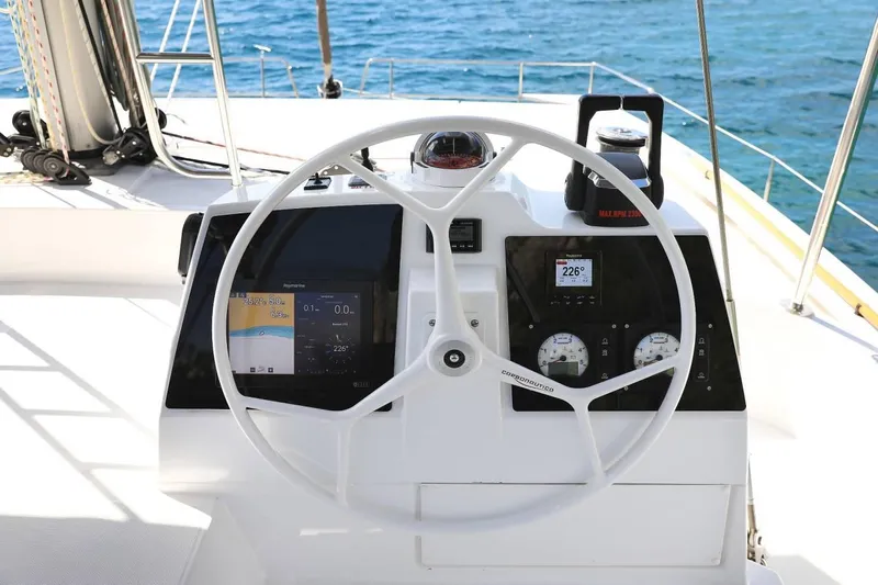 Blureverie Yacht Photos Pics Steering wheel and dashboard of a 2021 Bali 4.8 yacht with navigation instruments.