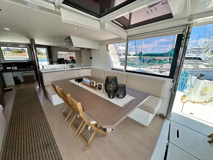 Blureverie Yacht Photos Pics Modern interior of 2021 Bali 4.8 yacht with dining area and marina view.