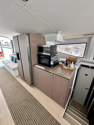 Blureverie Yacht Photos Pics Modern interior of 2021 Bali 4.8 yacht with kitchen and seating area.