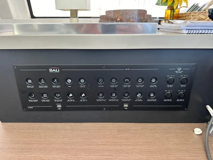 Blureverie Yacht Photos Pics Control panel of a 2021 Bali 4.8 yacht with various switches and indicators.