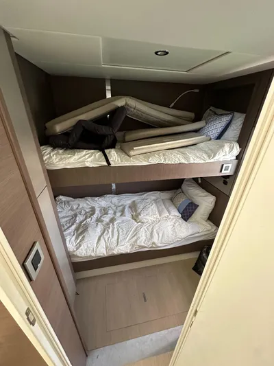 Blureverie Yacht Photos Pics Bunk beds in a 2021 Bali 4.8 yacht cabin with modern design and cozy bedding.