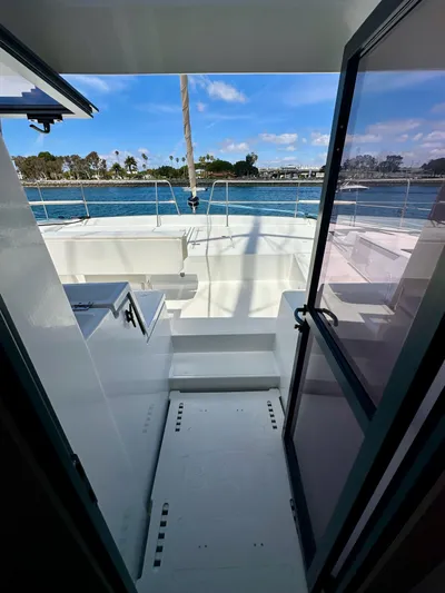 Blureverie Yacht Photos Pics 2021 Bali 4.8 yacht interior with ocean view through open door.