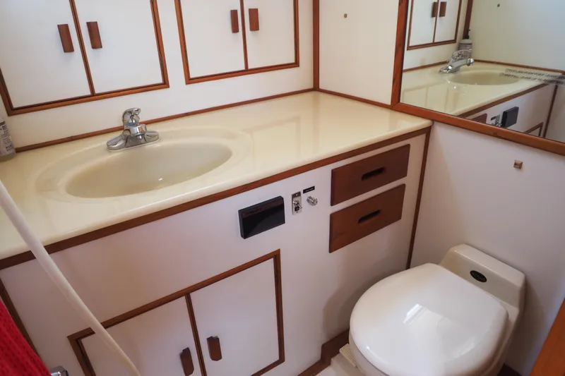"bootlegger"-repowered Yacht Photos Pics Bathroom interior of 1995 Grand Banks 38 Eastbay EX yacht, featuring sink and toilet.
