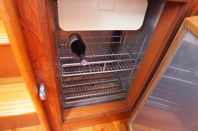 "bootlegger"-repowered Yacht Photos Pics Wine bottle in a wooden cabinet fridge on a 1995 Grand Banks 38 Eastbay EX yacht.