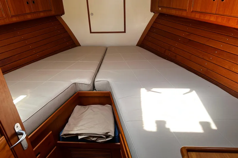 "bootlegger"-repowered Yacht Photos Pics Cabin interior of 1995 Grand Banks 38 Eastbay EX with twin beds and wooden cabinetry.