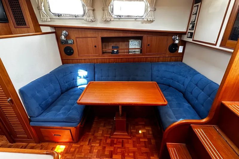 "bootlegger"-repowered Yacht Photos Pics 1995 Grand Banks 38 Eastbay EX interior with blue seating and wooden table.