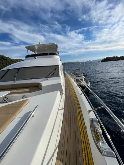 Tmr Yacht Photos Pics Luxurious 2018 Custom 84 yacht cruising on serene waters under a blue sky.