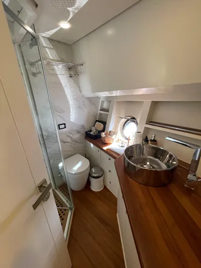 Tmr Yacht Photos Pics Luxurious yacht bathroom with wood accents, modern fixtures, and a glass shower. Custom 84, 2018 model.