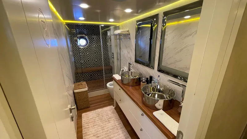 Tmr Yacht Photos Pics Luxurious yacht bathroom with dual sinks, modern fixtures, and elegant lighting, Custom 84 model, 2018.